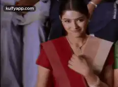 Woman in red sari gives thumbs up