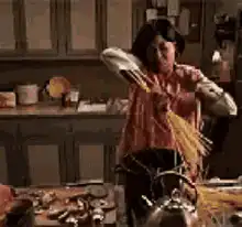 Woman throws spaghetti at wall