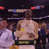 Snoop Dogg raises cup at basketball game