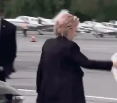 Hillary Clinton climbing airplane stairs