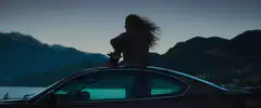 woman sitting on car roof