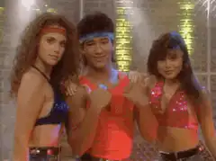 Three people in 80s workout gear dancing