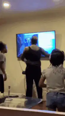 Woman smashes TV with a bat