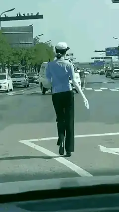 Female traffic police officer walking on street