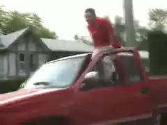 Man falls off moving red truck