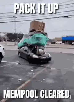 Car overloaded with boxes and tarp