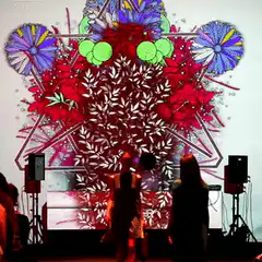 Dancers in front of psychedelic geometric projection