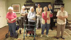 elderly people dancing in living room