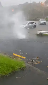 Storm drain geyser erupts on street