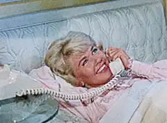 Doris Day laughing on the phone in bed