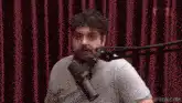 Man gesturing wildly at microphone