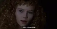 Young girl with curly hair says I want some more