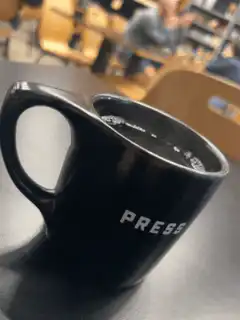 black coffee cup with press text