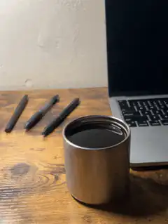 Coffee cup steaming on desk