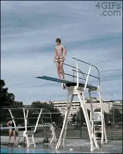 Man does a belly flop off a diving board