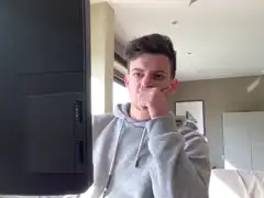 man covering mouth in front of tv