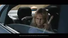 Woman driving with child playing recorder