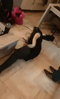 Woman sitting on floor shaking head