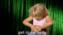 Little girl rubbing belly
