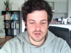 Man in grey hoodie talking