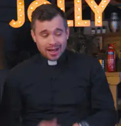 Priest talking and gesturing