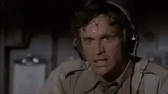 Man sweating profusely under headphones