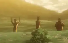 Three shirtless men standing in a field