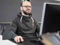 Man gives thumbs up at computer