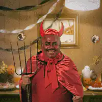 Man in devil costume surrounded by fire