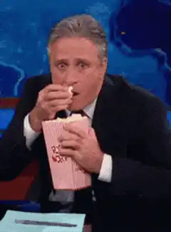 Jon Stewart eating popcorn