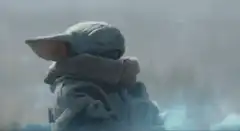 Baby Yoda hugging himself