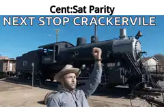 Man in cowboy hat raises fist in front of train