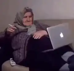 Old woman smoking with laptop