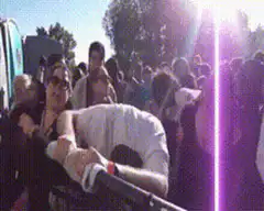 Man in white shirt leans on barrier at concert