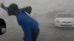 Man throws phone at car in rain