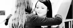 Two girls hugging in black and white