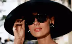 Woman in black hat and sunglasses