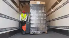 Worker struggles to fit pallet in truck
