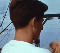 John F. Kennedy turns and smiles