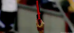 Hand holding a red flare gun firing