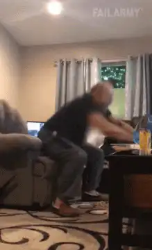 man hits balloon and falls over