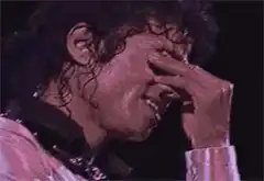 Michael Jackson wiping sweat from his eye