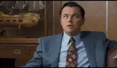 Leonardo DiCaprio coughing in a suit