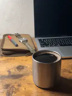 coffee cup on desk with laptop