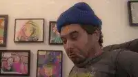 Man in blue beanie triggered