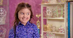Girl makes funny faces in blue shirt