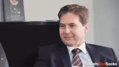 Man in suit smiling and nodding