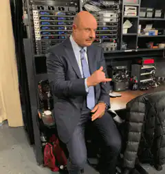 Man in suit pointing at server rack