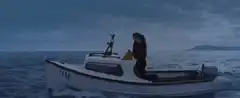 Two people kissing on a boat named Jim