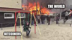 Kid on swing ignoring burning building